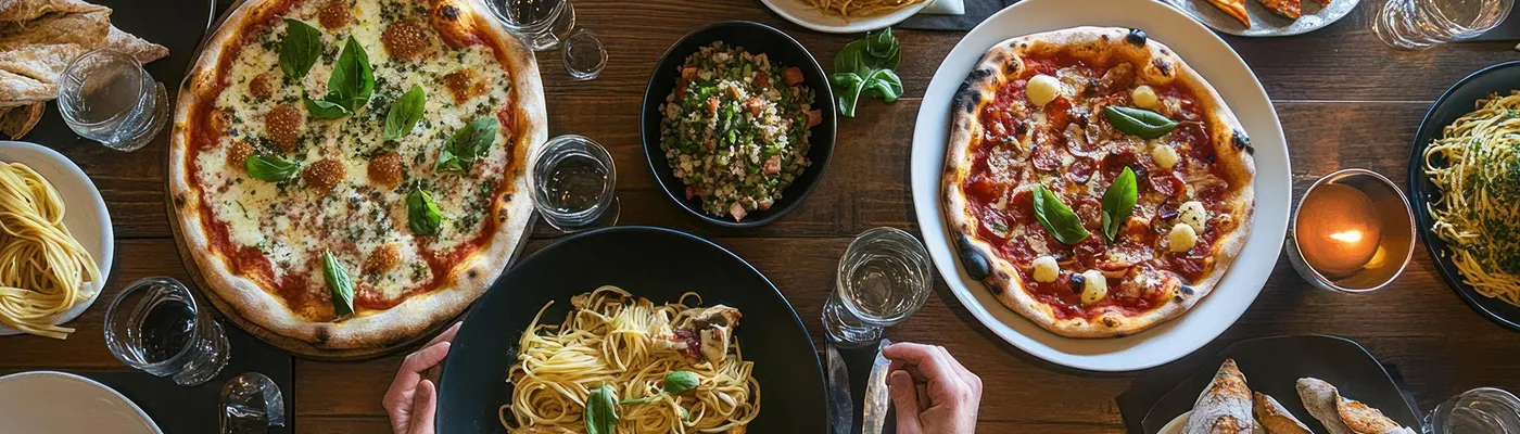 Pizza and pasta catering setup with variety of dishes for event